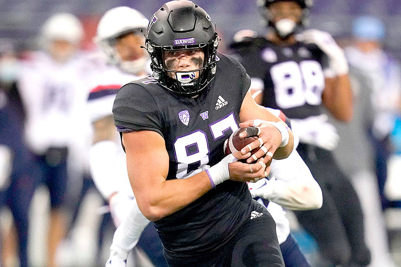 Washington's Cade Otton heads to the end zone to score on a 20-yard pass reception against Arizona during the second half of an NCAA college football game Saturday, Nov. 21, 2020, in Seattle. (AP Photo/Elaine Thompson)