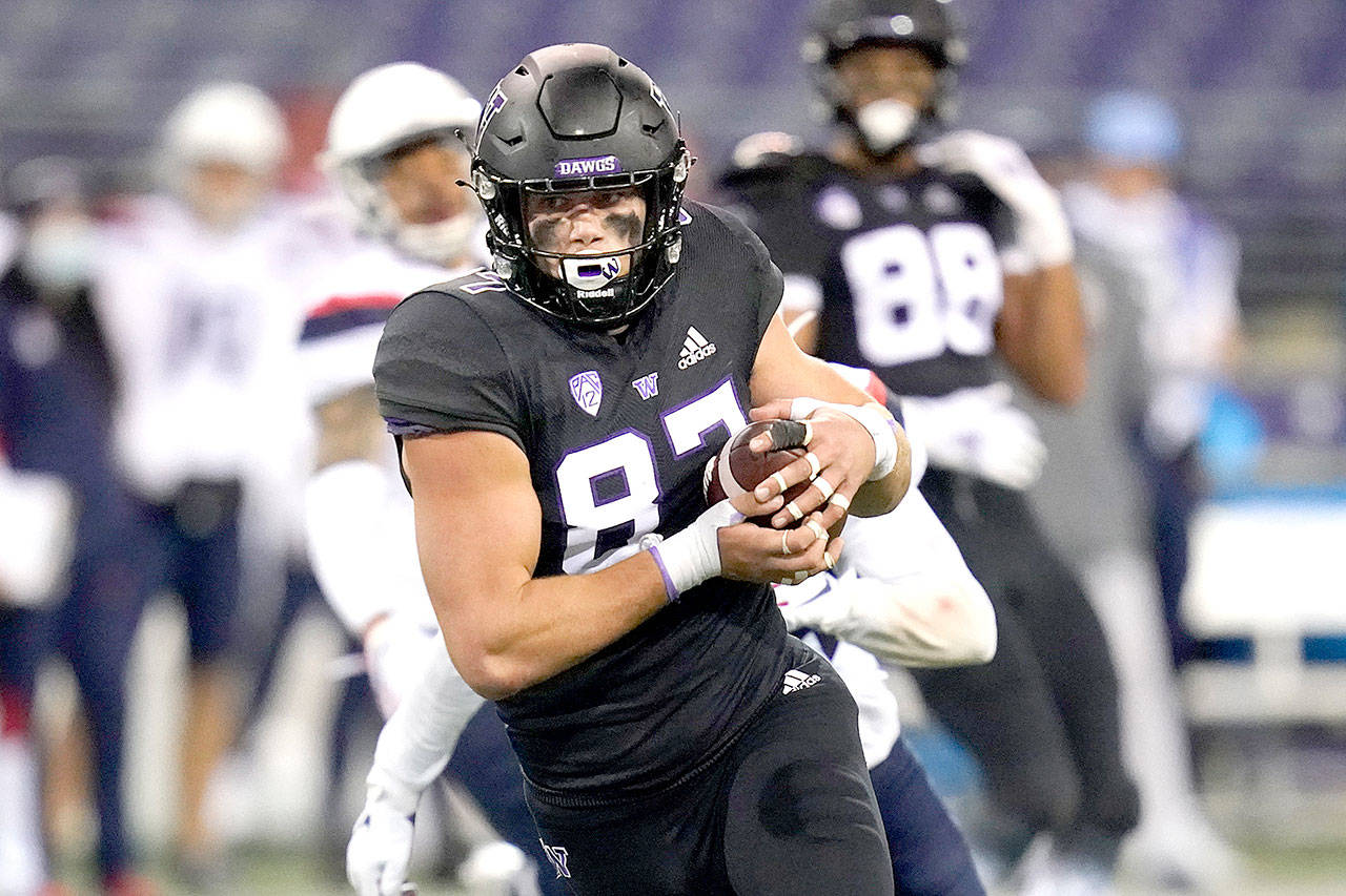 Washington’s Cade Otton heads to the end zone to score on a 20-yard pass reception against Arizona Saturday, Nov. 21, in Seattle. (Elaine Thompson/The Associated Press)