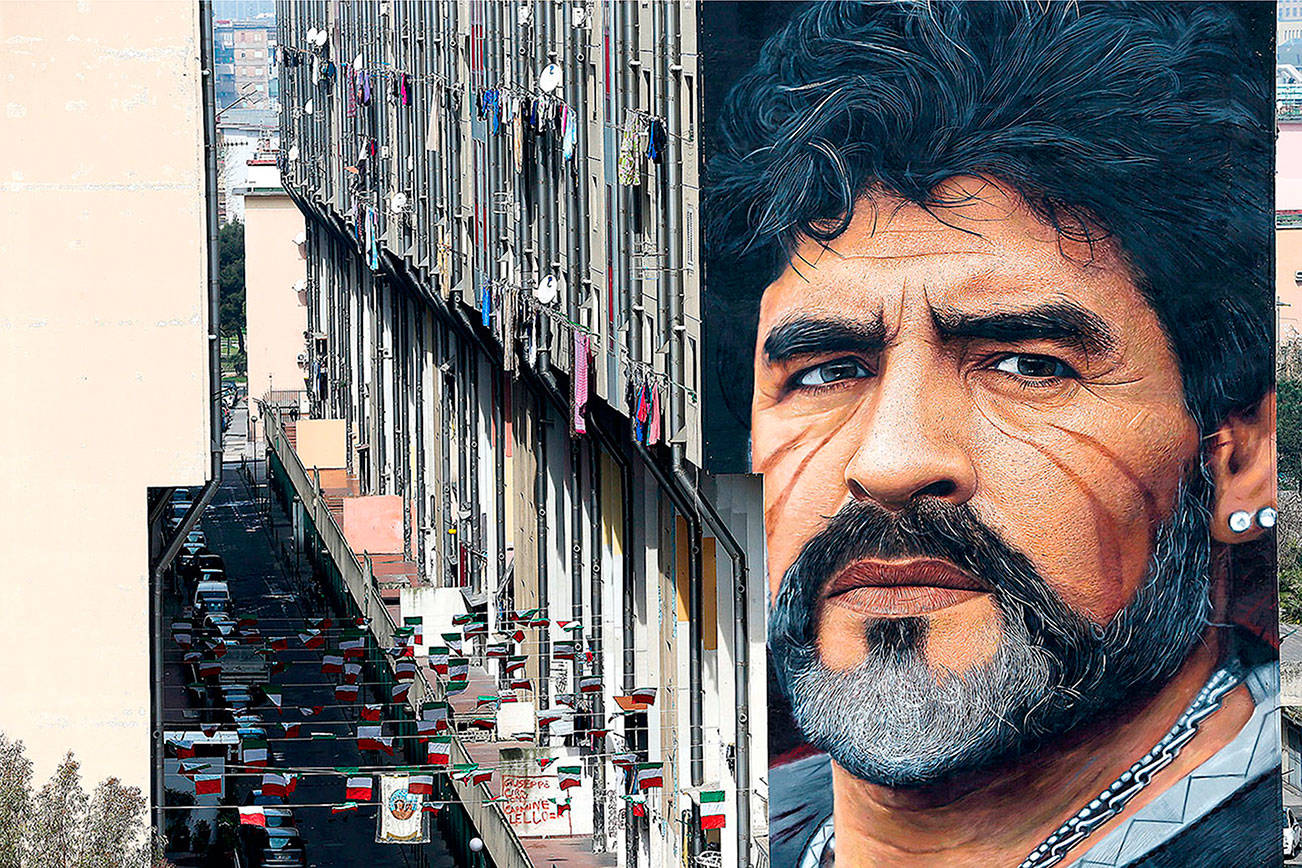A mural depicting Diego Maradona, by street artist Jorit, is painted on a building in Naples, Italy, March 24, 2017.  Diego Maradona has died. The Argentine soccer great was among the best players ever and who led his country to the 1986 World Cup title before later struggling with cocaine use and obesity. He was 60. (Marco Cantile/LaPresse via AP)