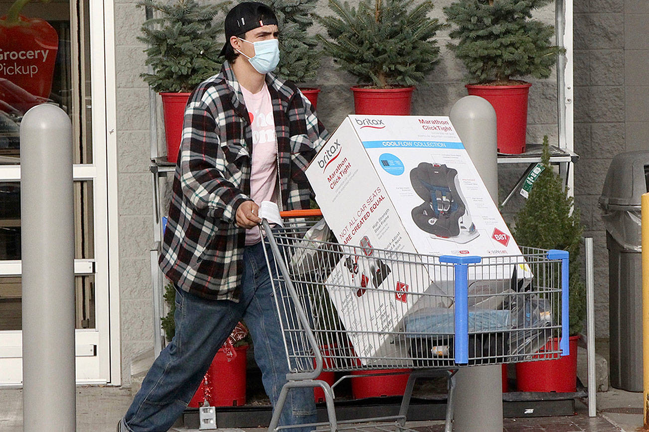Walmart was very busy on Black Friday with customers getting those special gifts and items on sale.
	ID: Roland Gagnon Jr. of Neah Bay came all the way in to Walmart for special bargain he needed like this car seat he purchased
(I tried to shoot shoppers at 5 AM but there was very few at that early hour so I shot this a little later on Black Friday in front of Walmart.) dlogan