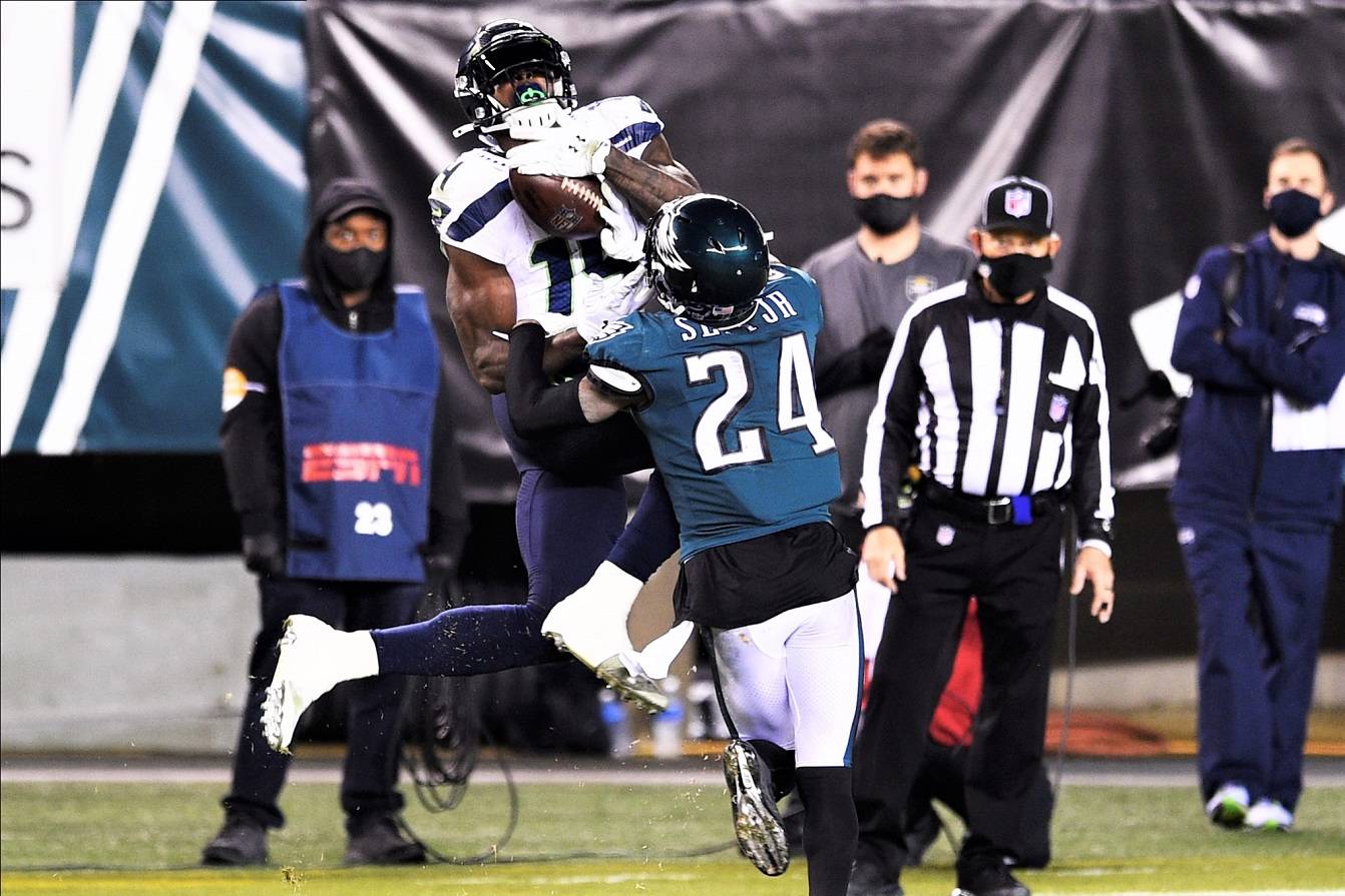 Seattle Seahawks’ DK Metcalf (14) catches a pass against Philadelphia Eagles’ Darius Slay (24) during the second half Monday in Philadelphia. (AP Photo/Derik Hamilton)