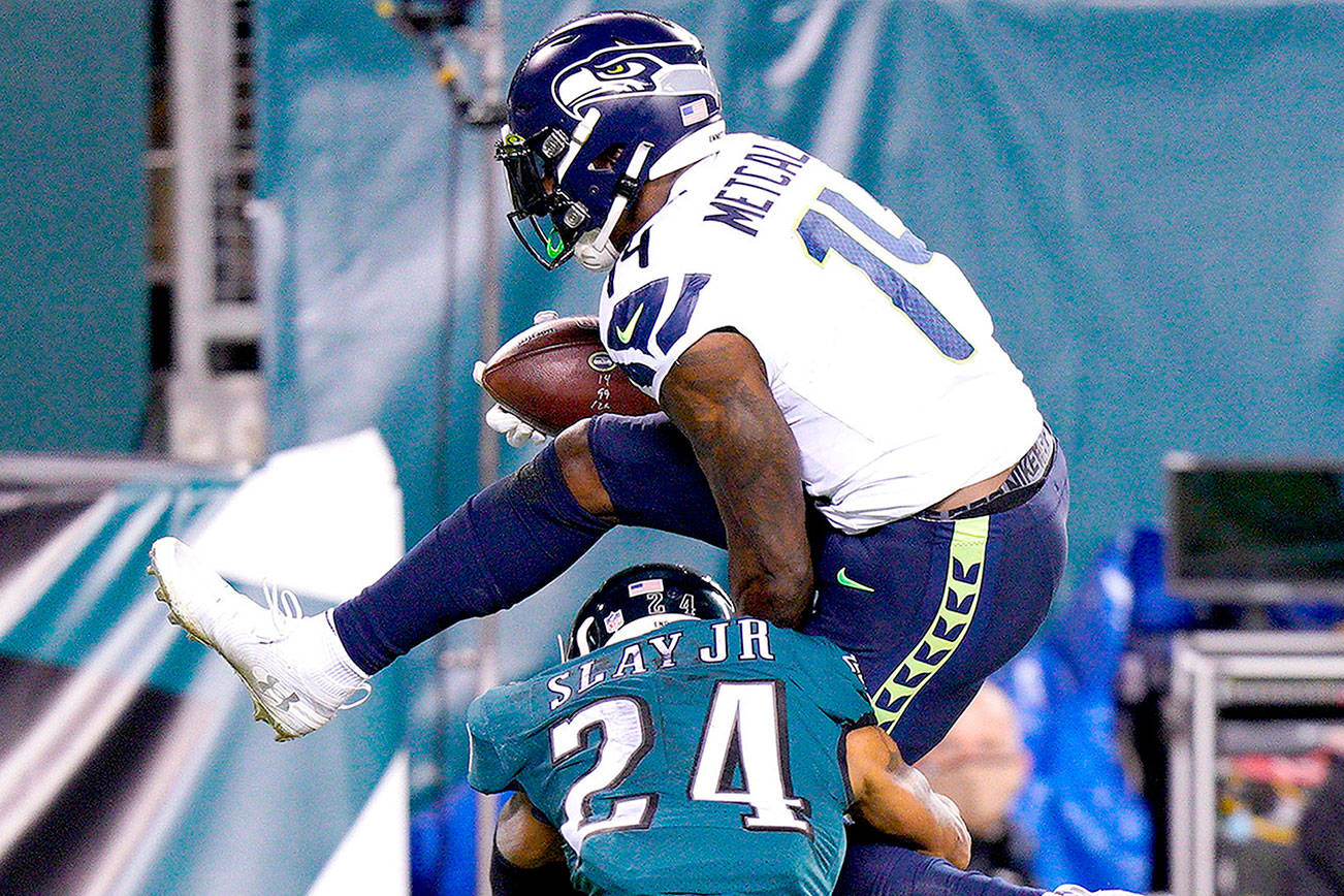 Seattle Seahawks' DK Metcalf (14) tries to get past Philadelphia Eagles' Darius Slay (24) during the first half of an NFL football game, Monday, Nov. 30, 2020, in Philadelphia. (AP Photo/Chris Szagola)