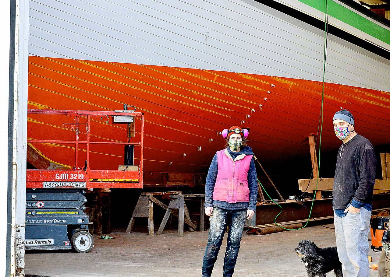 The Western Flyer, made famous in John Steinbeck’s “The Log from the Sea of Cortez,” is being restored at the Shipwrights Cooperative in Port Townsend with Ginny Wilson, Tim Lee and Tuff the dog on the crew. A tour of the project is one of the items in the Jefferson County Historical Society’s AHA Auction wrapping up this weekend. (Diane Urbani de la Paz/Peninsula Daily News)