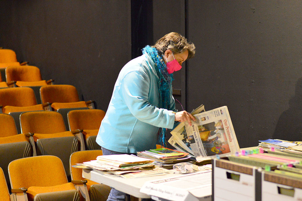 As remodeling begins at Key City Public Theatre, artistic director Denise Winter sorts through the playhouse archives. (Diane Urbani de la Paz/Peninsula Daily News)