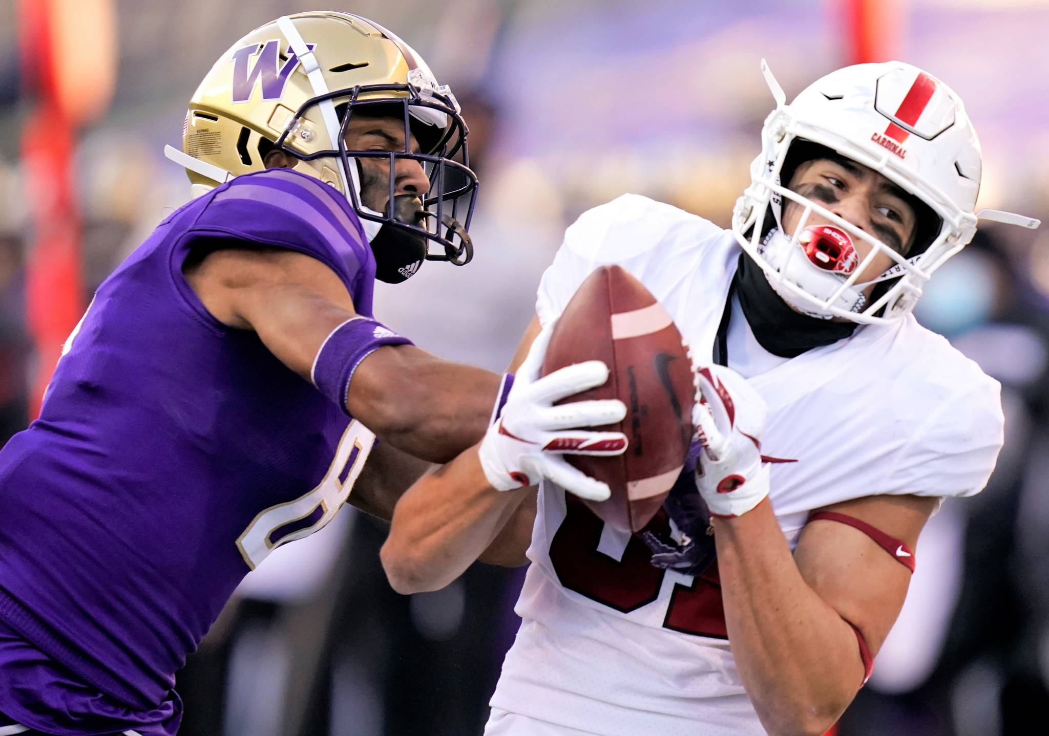 Stanford wide receiver Brycen Tremayne, right, catches a 33-yard pass as Washington defensive back Keith Taylor defends in the second half of an NCAA college football game Saturday, Dec. 5, 2020, in Seattle. (AP Photo/Elaine Thompson)