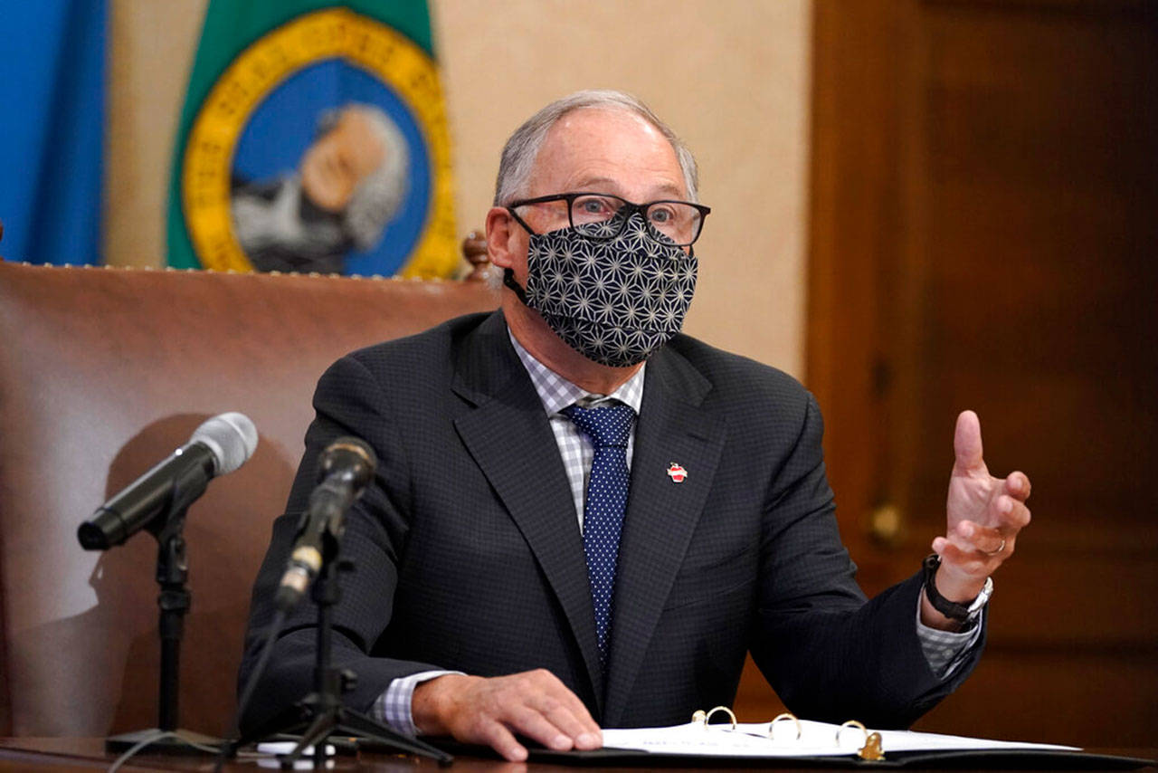 Washington Gov. Jay Inslee speaks during a news conference Monday in Olympia. On Tuesday, he announced the extension of COVID-19 restrictions until Jan. 4. (Ted S. Warren/Associated Press)