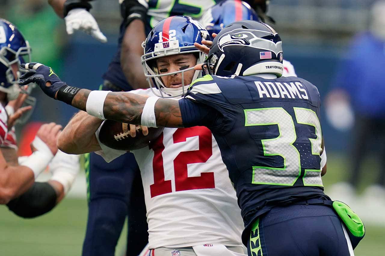 Seattle Seahawks strong safety Jamal Adams (33) sacks New York Giants quarterback Colt McCoy (12) during the first half of an NFL football game Dec. 6 in Seattle. (Elaine Thompson/The Associated Press)