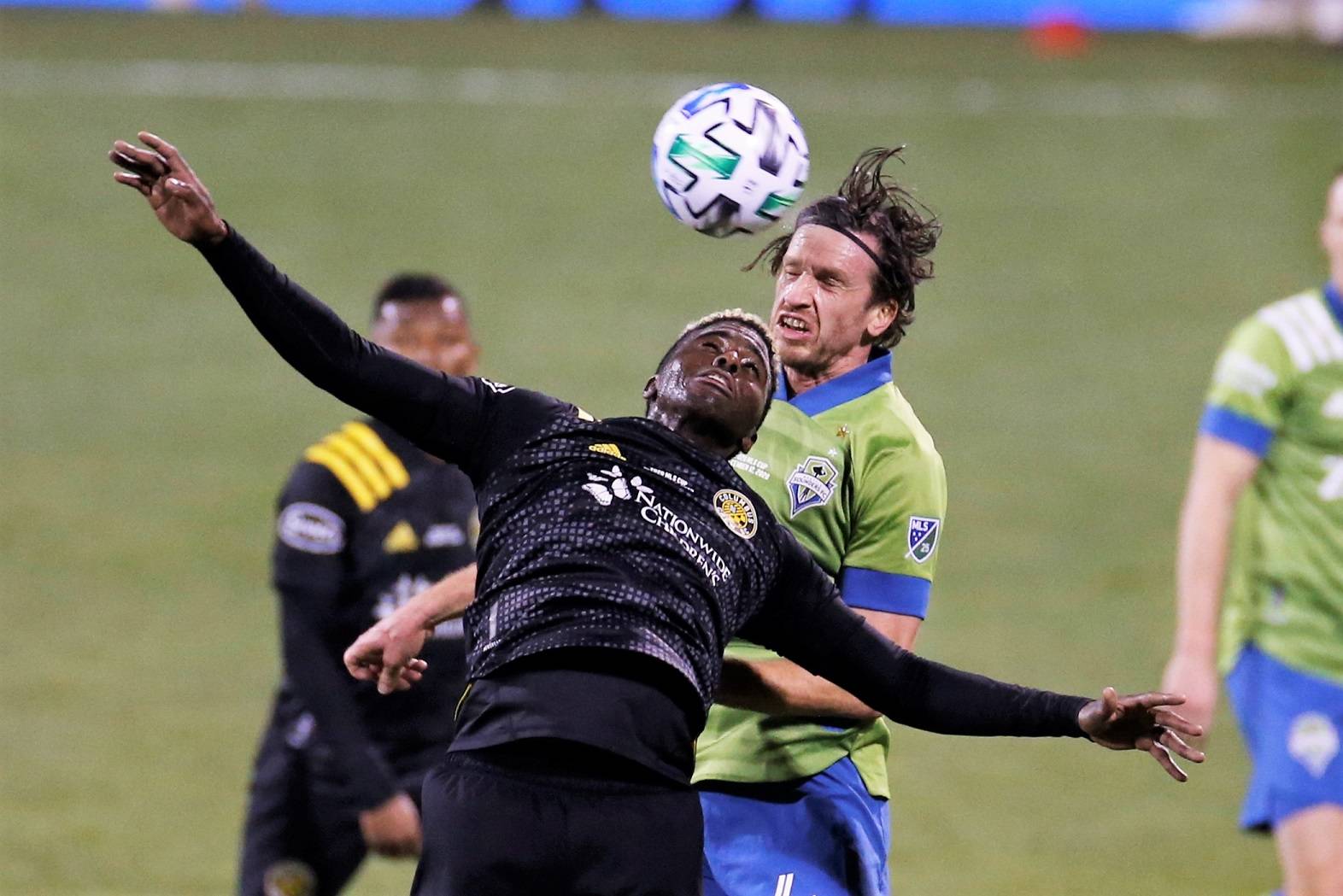Columbus Crew's Gyasi Zardes, front, and Seattle Sounders' Gustav Svensson vie for a head ball during the second half of the MLS Cup championship game Saturday, Dec. 12, 2020, in Columbus, Ohio. The Crew won 3-0. (AP Photo/Jay LaPrete)