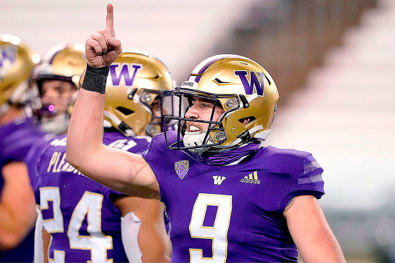 Washington quarterback Dylan Morris gestures after Washington defeated Utah 24-21 Nov. 28 in Seattle. (AP Photo/Ted S. Warren)