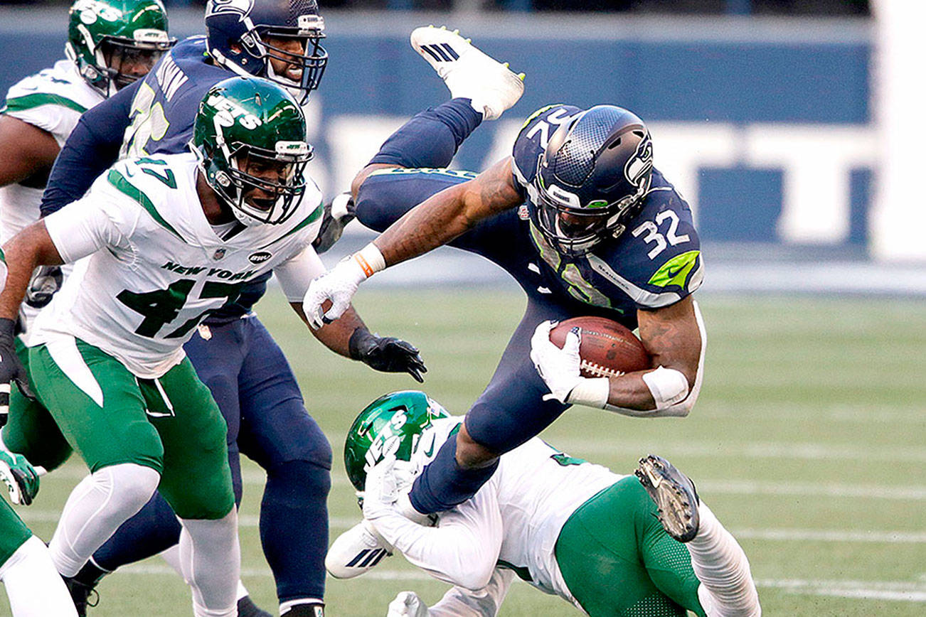 Seattle Seahawks running back Chris Carson (32) is upended on a carry against the New York Jets during the second half of an NFL football game, Sunday, Dec. 13, 2020, in Seattle. (AP Photo/Lindsey Wasson)