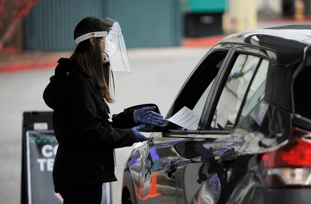 Patient-care navigator Tabatha Spegal talks with a patient at the Jamestown Family Clinic’s COVID-19 drive-thru testing site earlier this month. (Michael Dashiell/Olympic Peninsula News Group)