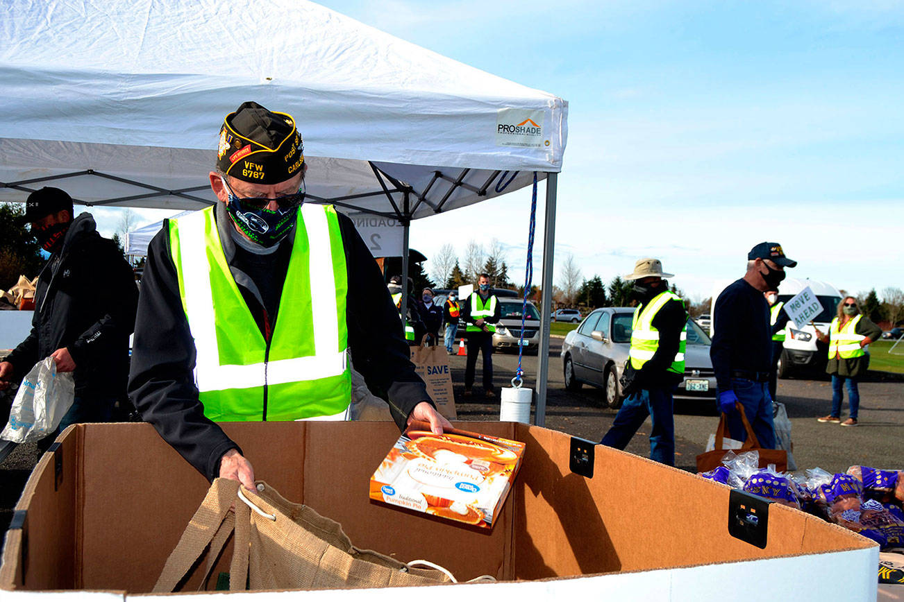 Volunteers like Calvin Barnard, senior vice commander of Carlsborg VFW Post 6787, helped    distribute food at the Family Holiday Meal Bay program on Nov. 20. Dozens of volunteers return on Dec. 18 to help provide food for Christmas. Sequim Gazette photo by Matthew Nash
