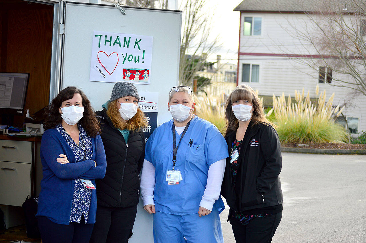 Working the COVID-19 vaccination drive-up station Thursday are, from left, Jefferson Healthcare staffers Jaimie Hoobler, Brandy Boyd, Jess Cigalotti and Lori Banks. (Diane Urbani de la Paz/Peninsula Daily News)