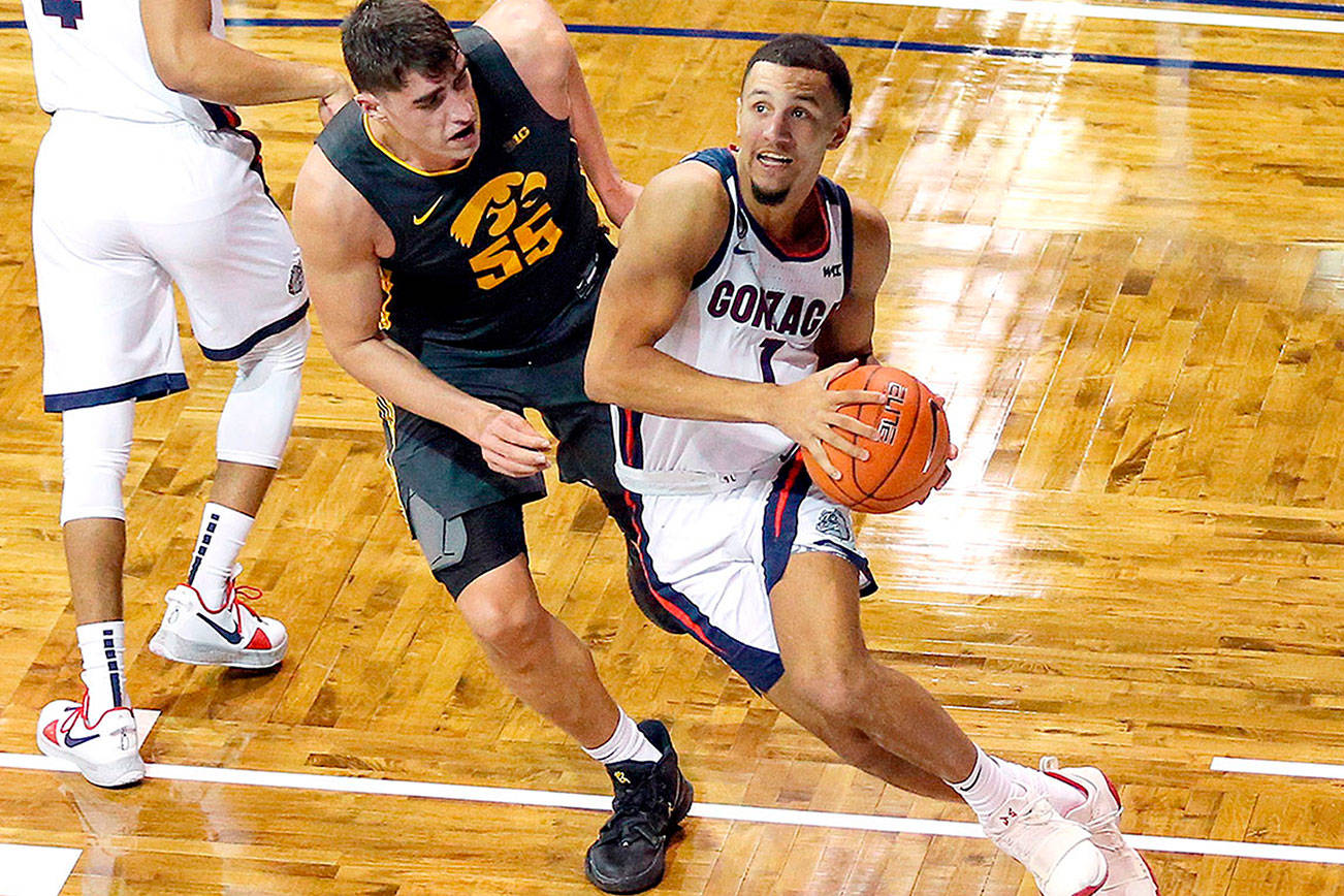 Gonzaga guard Jalen Suggs (1) drives the baseline against Iowa defender Luka Garza (55) during the second half of an NCAA college basketball game Saturday, Dec. 19, 2020 in SIoux Falls, S.D. (AP Photo/Josh Jurgens)