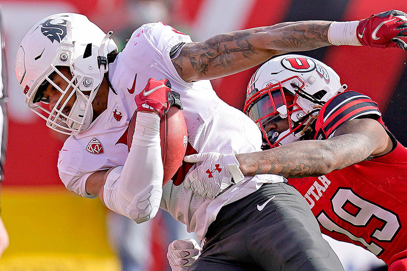 Washington State running back Deon McIntosh (3) scores against Utah safety Vonte Davis (19) during the first half of an NCAA college football game Saturday, Dec. 19, 2020, in Salt Lake City. (AP Photo/Rick Bowmer)