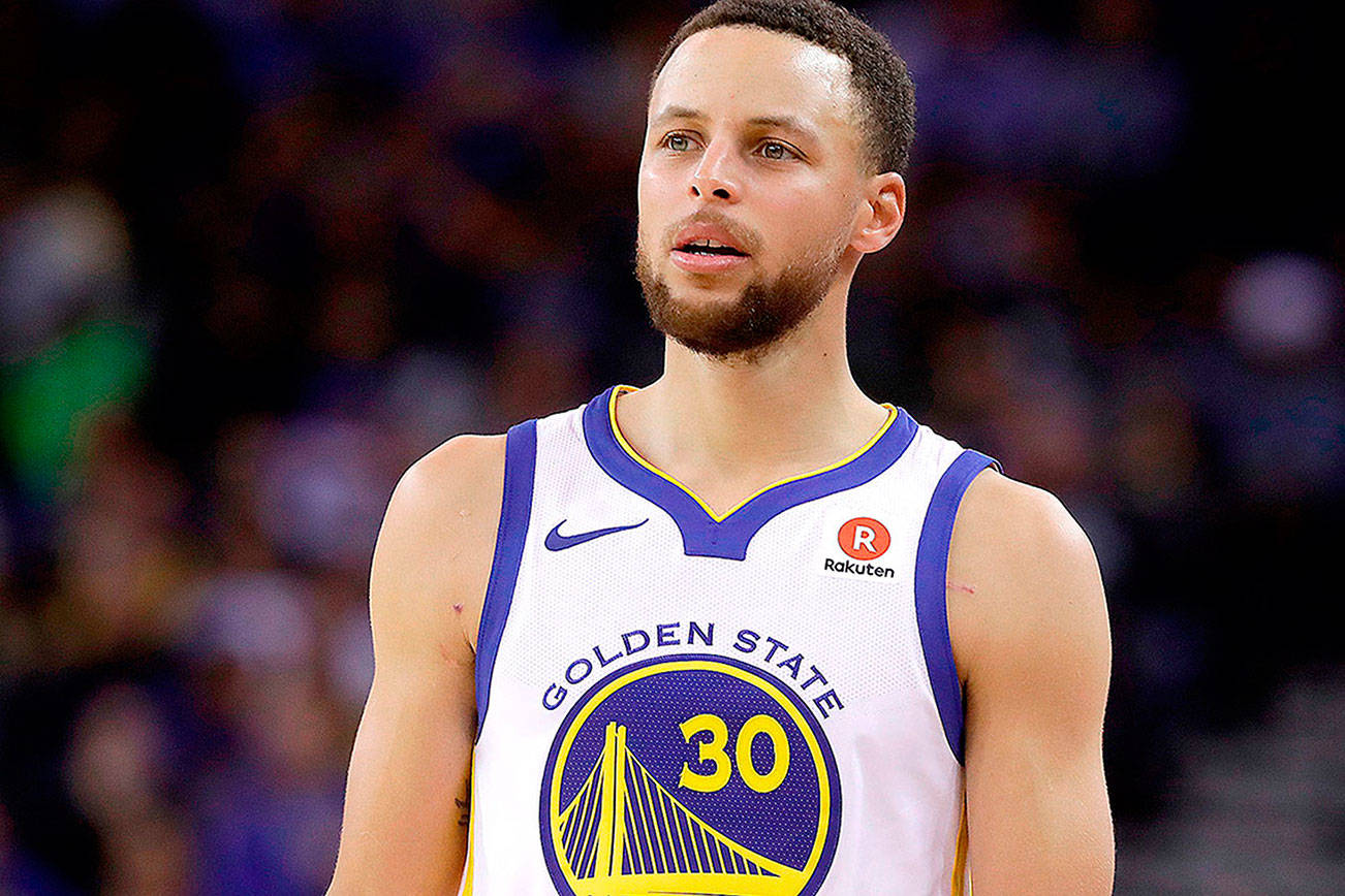 FILE - This March 6, 2018 file photo shows Golden State Warriors guard Stephen Curry during an NBA basketball game against the Brooklyn Nets in Oakland, Calif.  Sony Pictures Entertainment announced Monday, April 23, that it has struck a deal with the Golden State Warriors All-Star guard to produce television, film and possibly gaming projects. (AP Photo/Jeff Chiu, File)