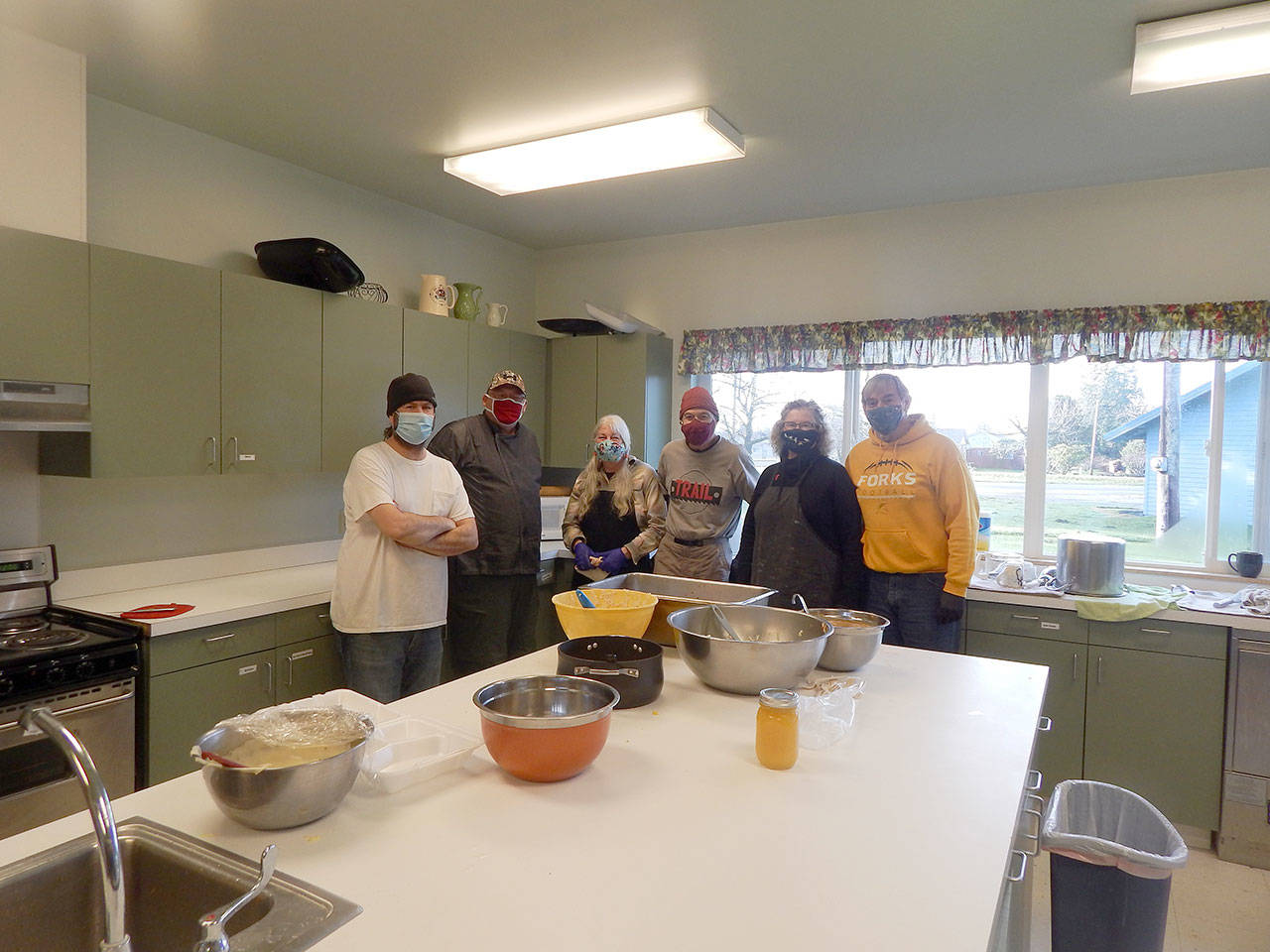 Feeding 5000 provided Christmas lunches to go on Tuesday. Pictured are, from left, Todd McGrail, Eugene Fraker, Doris Villarreal, Mark Calamar, Sherry Schaaf and Pastor Bob Schwartz in the kitchen at the Forks Community Center. Feeding 5000 is a nonprofit organization funded by the community and local churches. It serves free meals each Tuesday. (Christi Baron/Olympic Peninsula News Group)
