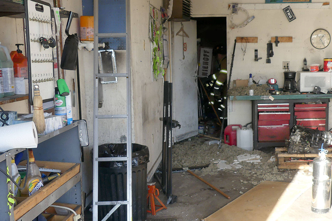 Owner Charles Gary and mechanic David Stratton extinguished an oil rag fire in this shop on Tuesday.