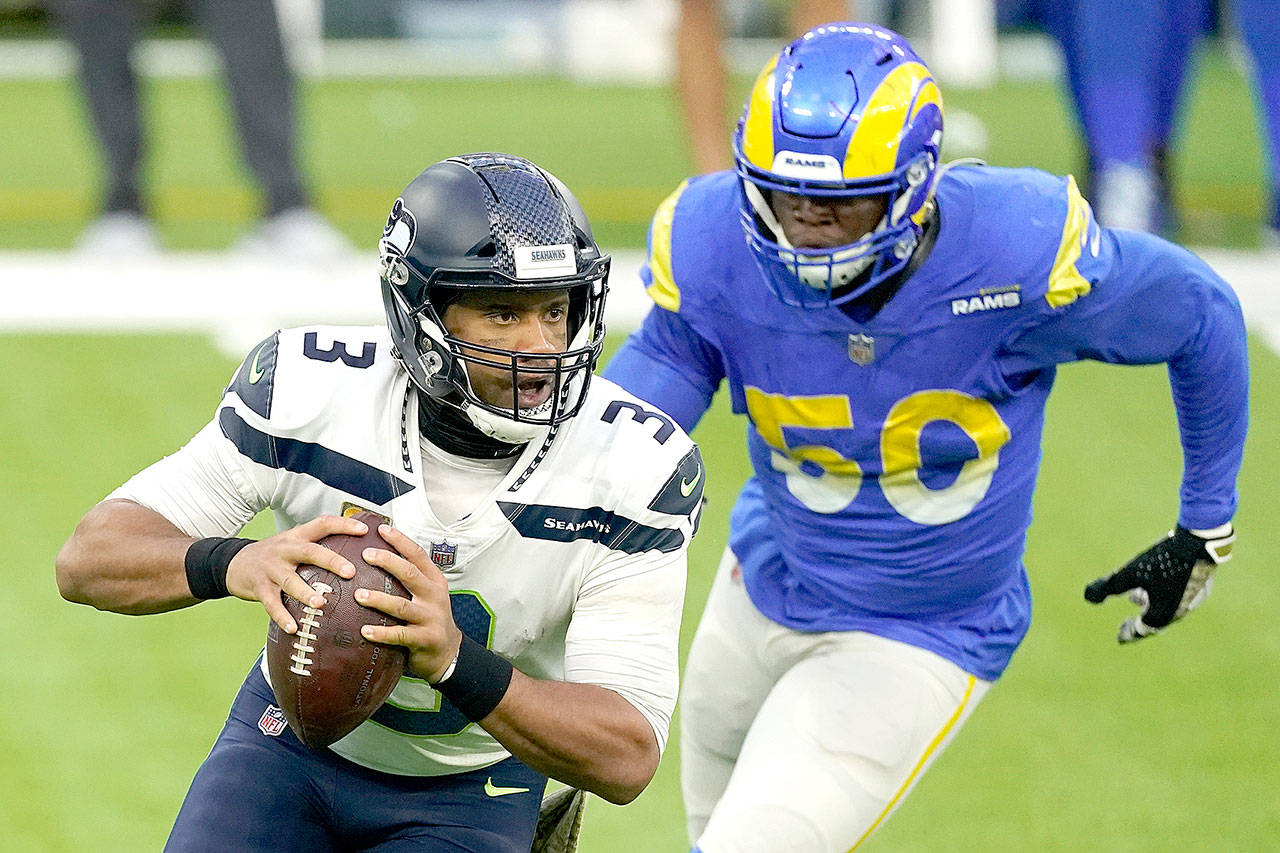 Seattle Seahawks quarterback Russell Wilson, left, gets some pressure from Los Angeles Rams outside linebacker Samson Ebukam during an NFL football game Sunday, Nov. 15, 2020, in Inglewood, Calif. (AP Photo/Ashley Landis)