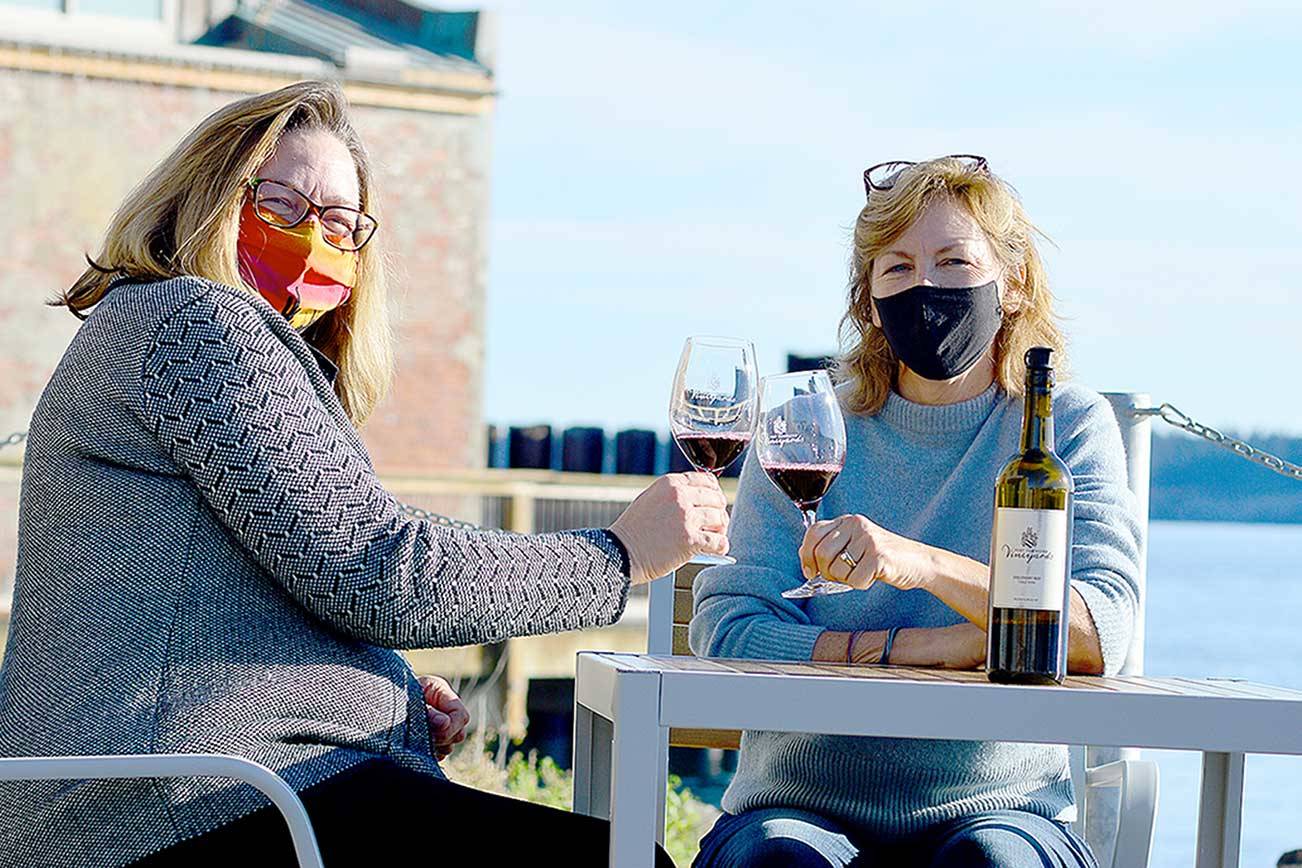 Tasting room lead Heidi Haney, left, and co-owner Karle Coppenrath await the day when the restored Port Townsend Vineyards Vintage Downtown building and plaza can host the gatherings it's designed for. (Diane Urbani de la Paz/Peninsula Daily News)