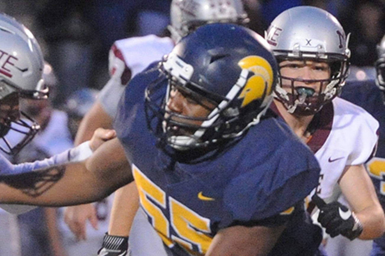 Forks' Trey Baysinger (55) tackles Montesano quarterback Sam Winter during a 2019 contest at Spartan Stadium. (Lonnie Archibald/For Peninsula Daily News)
