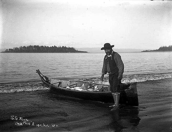 1917.115.16.jpg: Makah Fisherman with a canoe full of halibut. Photo by Samuel Morse c1902. Washington State Historical Society.