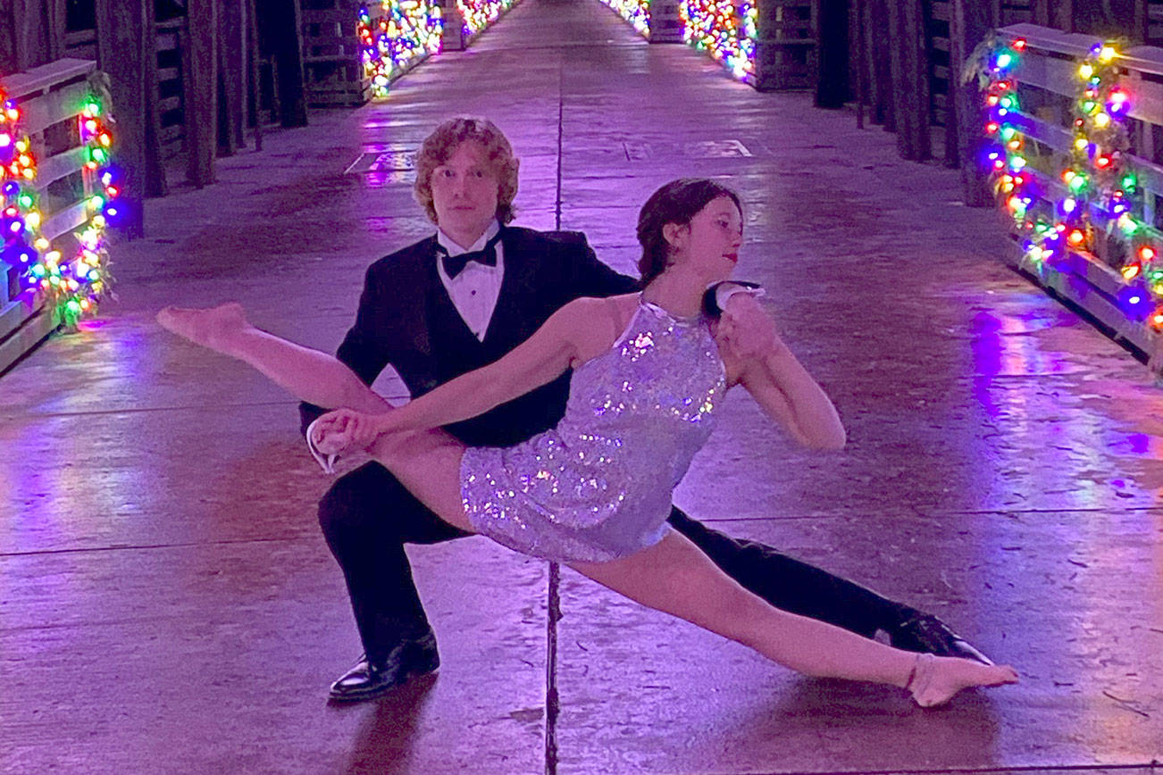 Logan Laxson and Mia Underwood move their Sequim Acrobatics rehearsals outdoors, using the Dungeness Railroad Bridge as a stage for a Dec. 19 photo shoot. Submitted photo