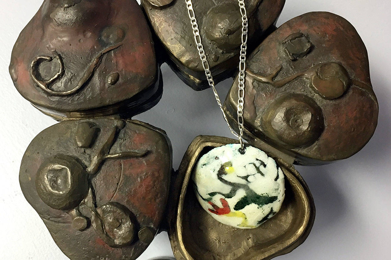 Necklace over bronze sculpture is by Katie Jablonski.