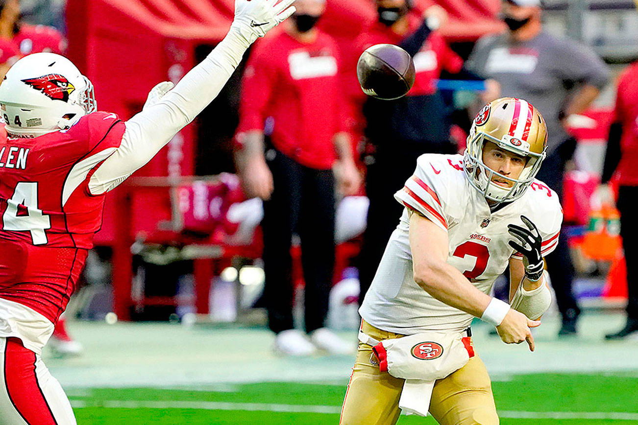 San Francisco 49ers quarterback C.J. Beathard (3) looks to pass as Arizona Cardinals defensive end Zach Allen (94) defends during the first half of an NFL football game, Saturday, Dec. 26, 2020, in Glendale, Ariz. (AP Photo/Rick Scuteri)