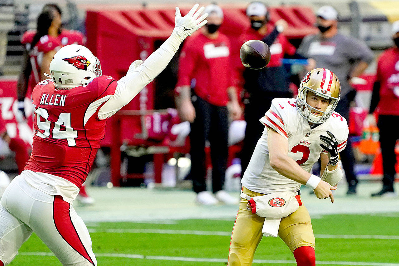 San Francisco 49ers quarterback C.J. Beathard (3) passes as Arizona Cardinals defensive end Zach Allen (94) rushes on Dec. 26 in Glendale, Ariz. Beathard is expected to start today against the Seattle Seahawks. (AP Photo/Rick Scuteri)
