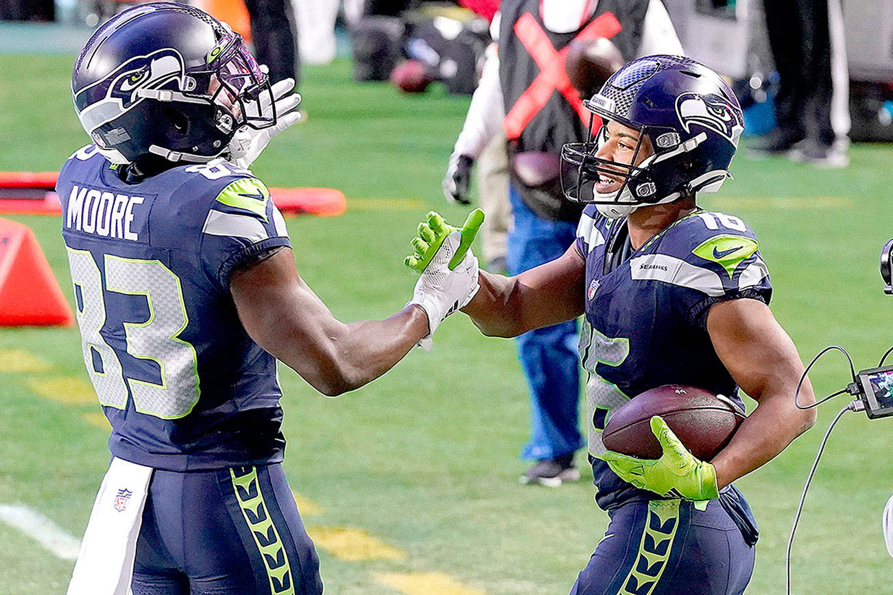 Seattle Seahawks wide receiver Tyler Lockett (16) celebrates his touchdown during the second half of an NFL football game against the San Francisco 49ers with wide receiver David Moore (83) , Sunday, Jan. 3, 2021, in Glendale, Ariz. (AP Photo/Ross D. Franklin)