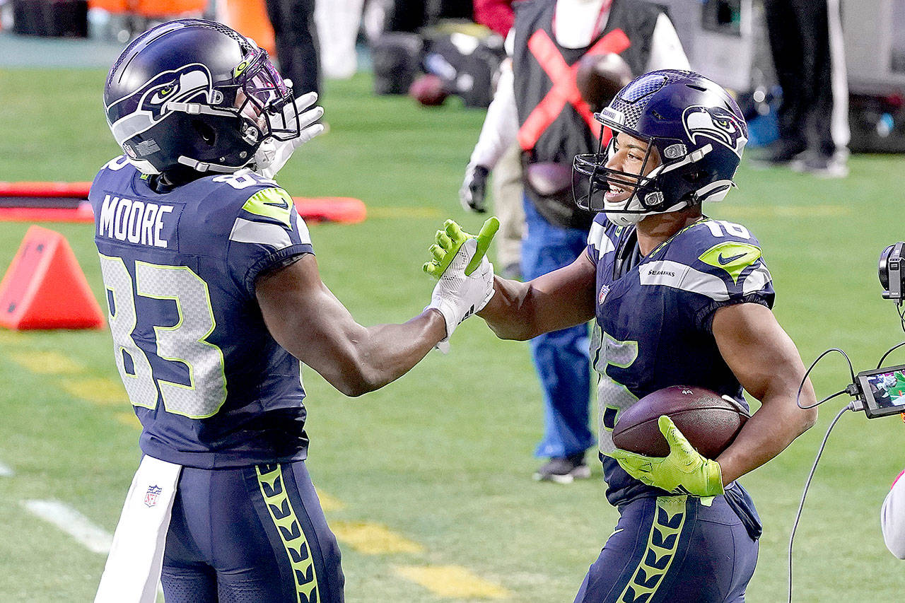Seattle Seahawks wide receiver Tyler Lockett (16) celebrates his touchdown during the second half of an NFL football game against the San Francisco 49ers with wide receiver David Moore (83) , Sunday, Jan. 3, 2021, in Glendale, Ariz. (AP Photo/Ross D. Franklin)