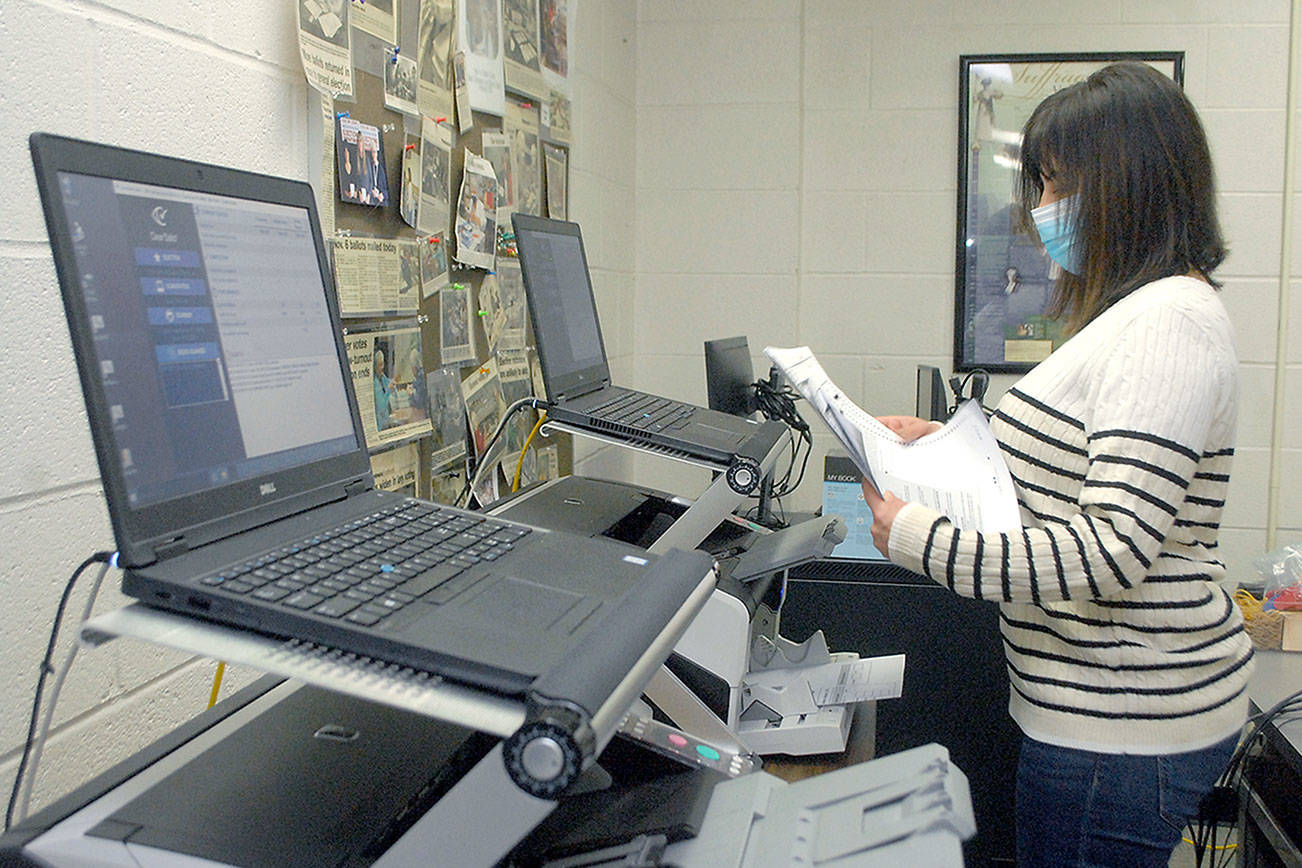Keith Thorpe/Peninsula Daily News
Clallam County Elections Supervisor Susan Johnson leafs through a stack of test ballots during a logic and accuracy test of the county's two ballot scanners on Wednesday at the Clallam County Courthouse in Port Angeles. The test, performed before every election, showed that the scanners came up with the expected results and passed certification.
