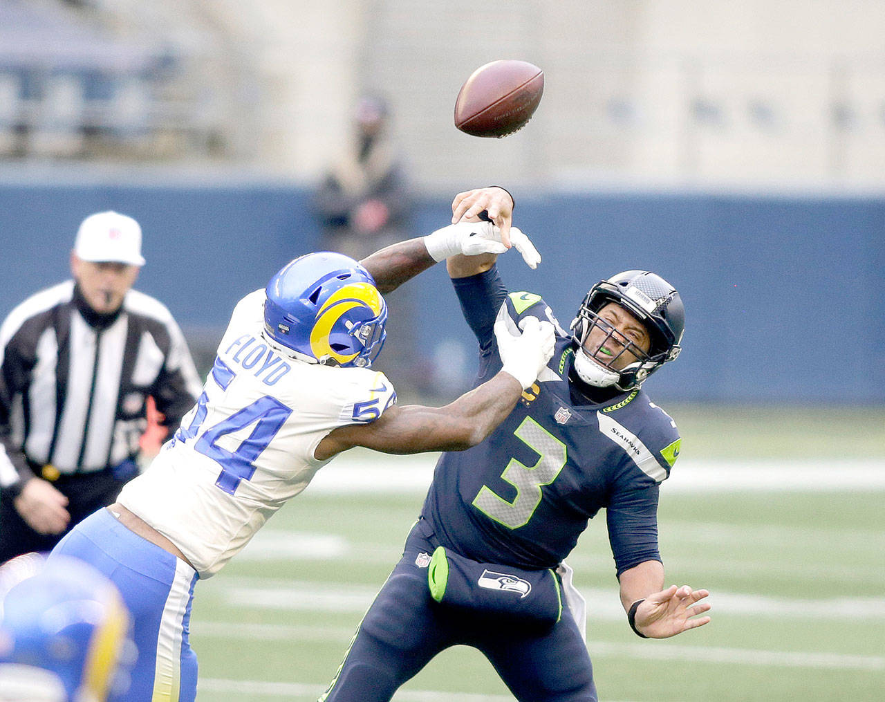 Los Angeles Rams outside linebacker Leonard Floyd (54) knocks the ball away as Seattle Seahawks quarterback Russell Wilson tries to pass during the first half of an NFL wild-card playoff football game, Saturday, Jan. 9, 2021, in Seattle. (AP Photo/Scott Eklund)