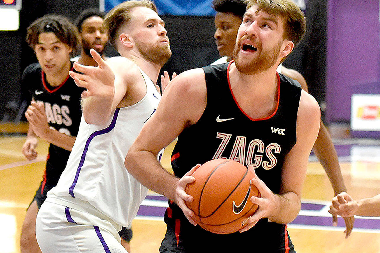 Gonzaga forward Drew Timme, right, drives to the basket on Portland forward Mikey Henn, left, during the first half of an NCAA college basketball game in Portland, Ore., Saturday, Jan. 9, 2021. (AP Photo/Steve Dykes)