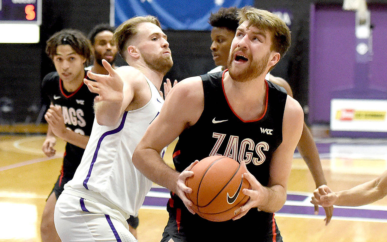 Gonzaga forward Drew Timme, right, drives to the basket on Portland forward Mikey Henn, left, on Portland, Ore., Saturday. (Steve Dykes/The Associated Press)