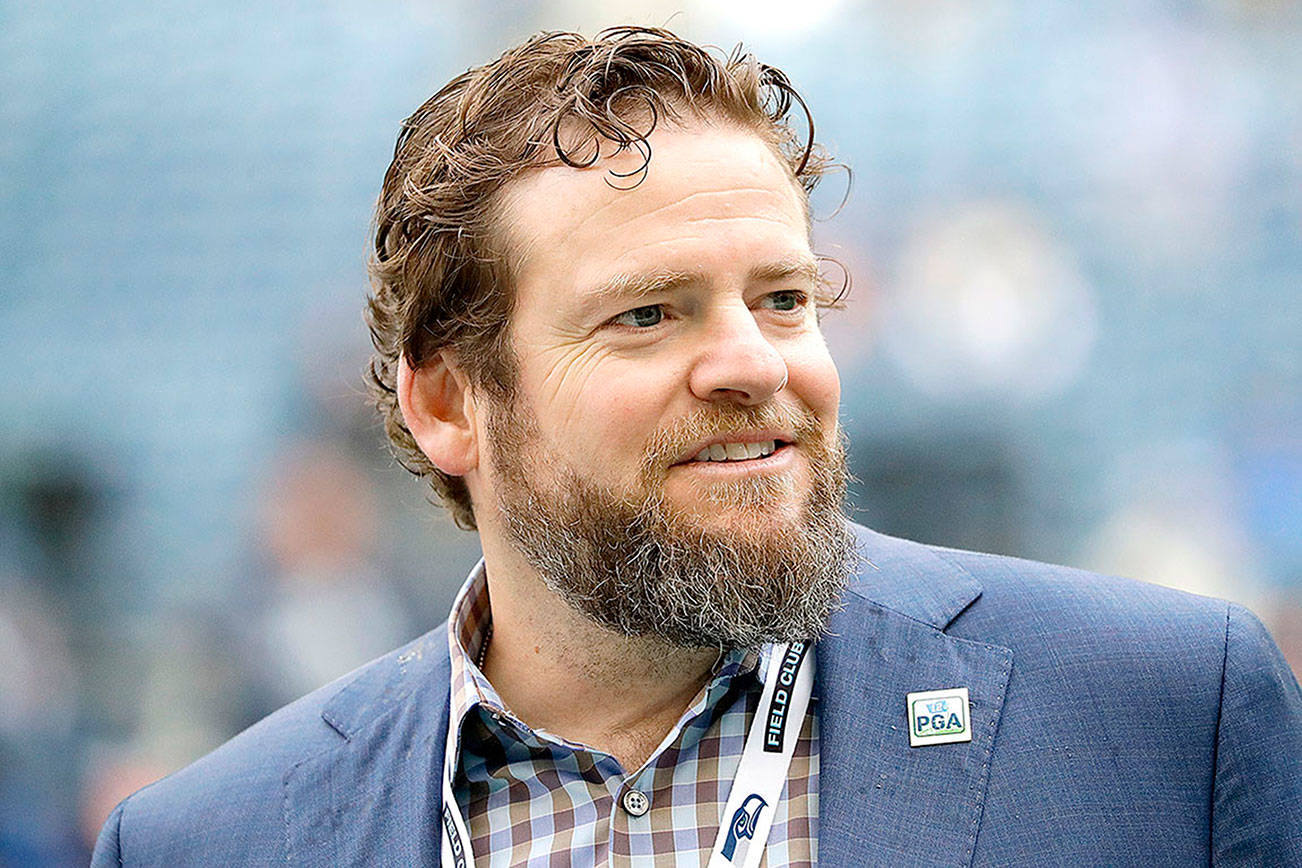 Seattle Seahawks general manager John Schneider walks on the field during warmups before an NFL football game against the Los Angeles Rams, Thursday, Oct. 3, 2019, in Seattle. The Seahawks have agreed to a contract extension with Schneider that will keep him tied to the franchise through the 2027 draft. (Elaine Thompson/The Associated Press)