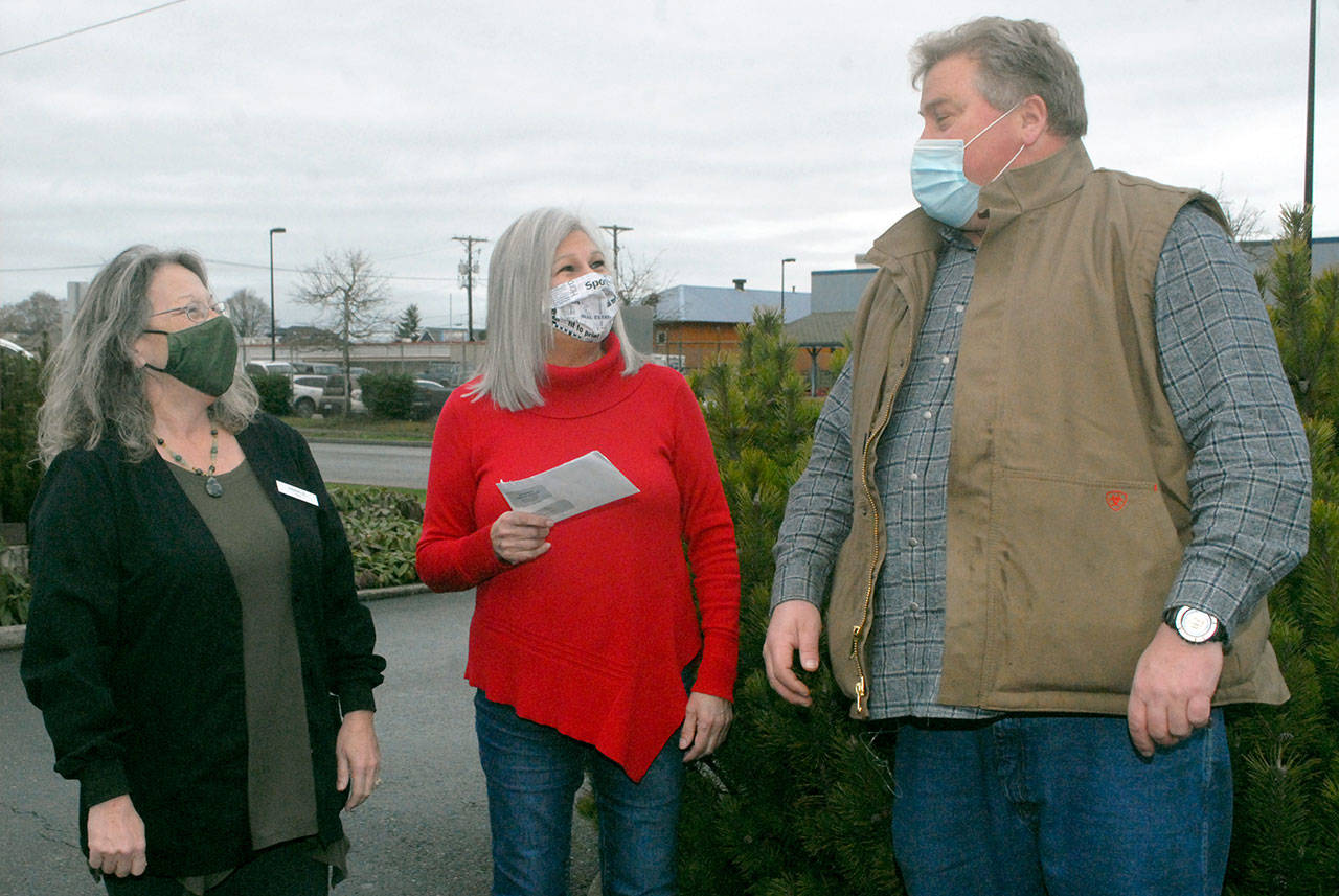 Vivian Elvis Hansen, marketing representative for the Peninsula Daily News, center, accepts a check for the Peninsula Home Fund from Jim’s Pharmacy chief financial officer Anna Shields, left, and Jim’s owner, Joe Cammick, on Tuesday in Port Angeles. The Home Fund received $885.65 as the pharmacy’s charity of the month. (Keith Thorpe/Peninsula Daily News)