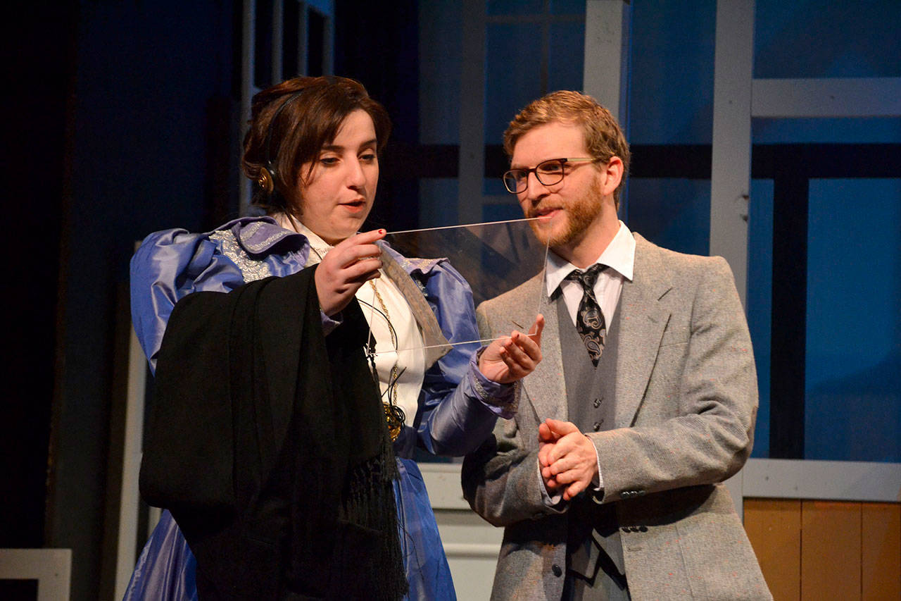 Ginny Holladay, as Henrietta Leavitt in “Silent Sky,” looks at a photograph of space on a glass plate with her boss’ apprentice Matt Forrest, as Peter Shaw, in the Harvard Observatory in November 2019. Holladay was recently named OTA’s executive director. (Matthew Nash /Olympic Peninsula News Group)