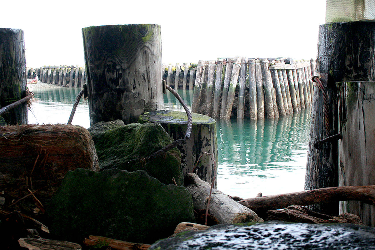 The north breakwater at Point Hudson is seen through a hole in the south breakwater, which an engineering firm suggested should be completely replaced at a cost between $5.5 million and $6.5 million. (Brian McLean/Peninsula Daily News)