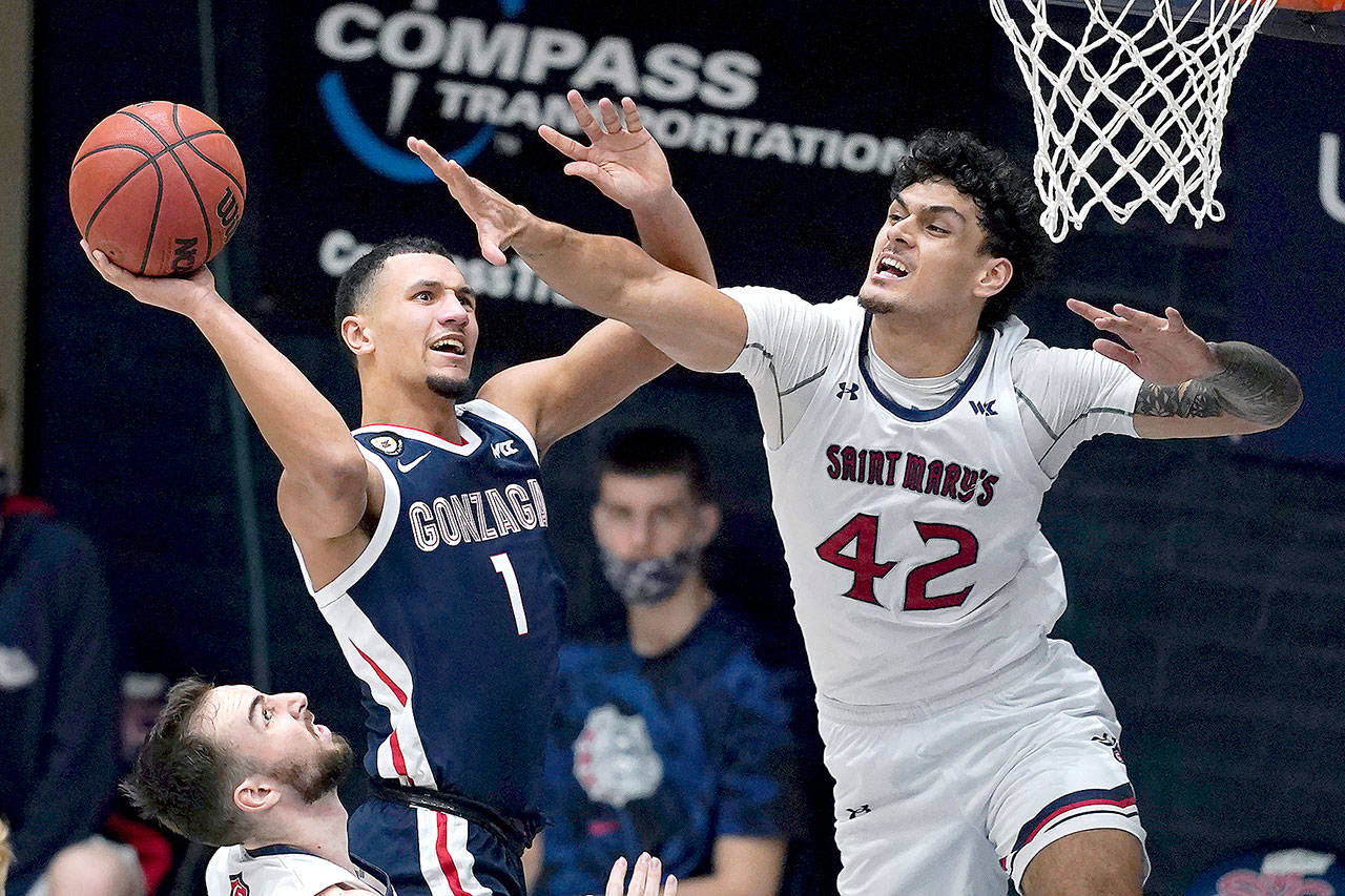 Gonzaga guard Jalen Suggs (1) shoots against Saint Mary’s forward Dan Fotu (42) during the second half of an NCAA college basketball game in Moraga, Calif., Saturday, Jan. 16, 2021. (AP Photo/Jeff Chiu)