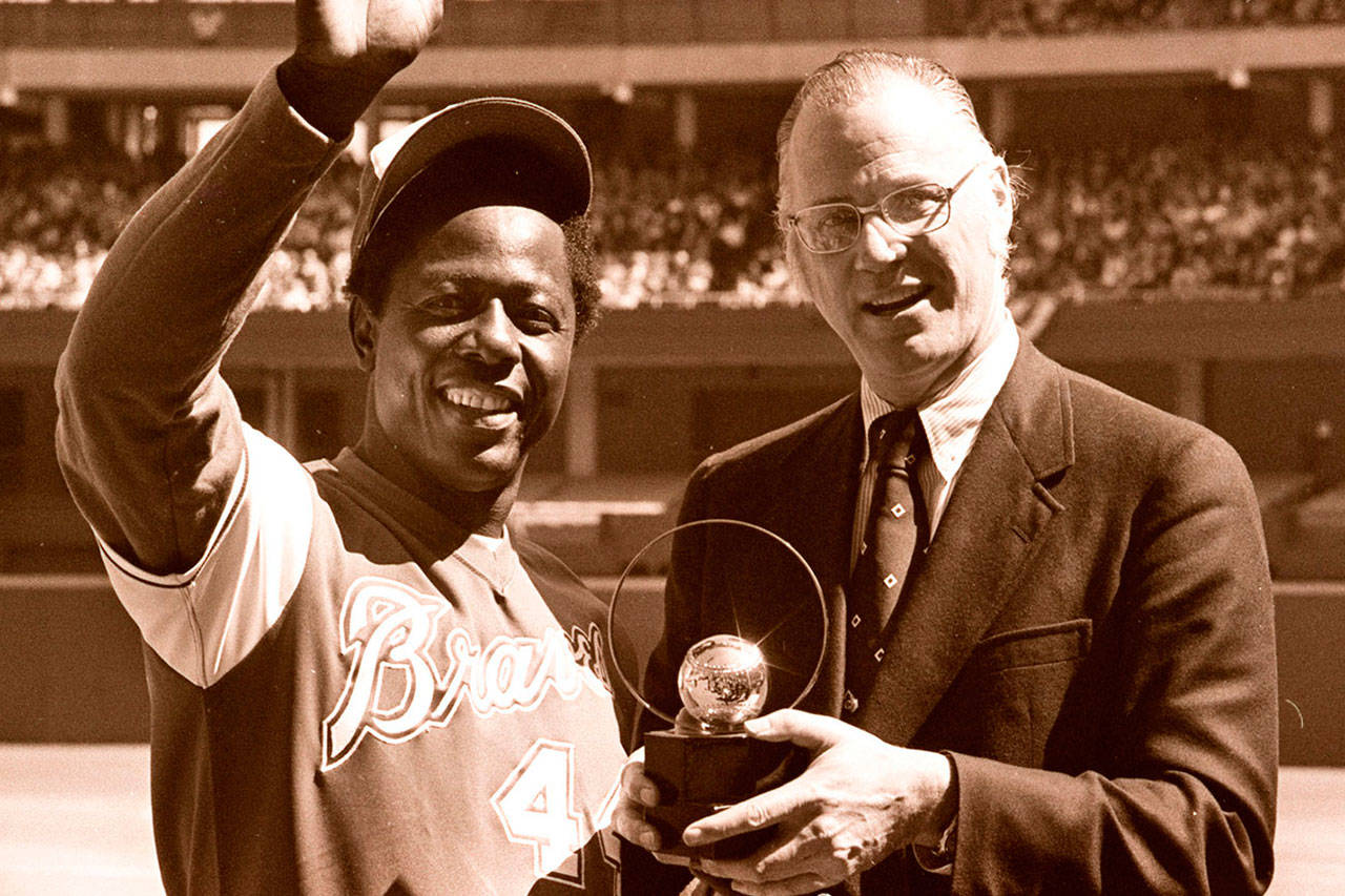 FILE - In this April 4, 1974, file photo, baseball commissioner Bowie Kuhn, right, presents Atlanta Braves' Hank Aaron with a trophy after he tied Babe Ruth's all-time home run record in Cincinnati. (AP Photo/Bob Johnson, File)