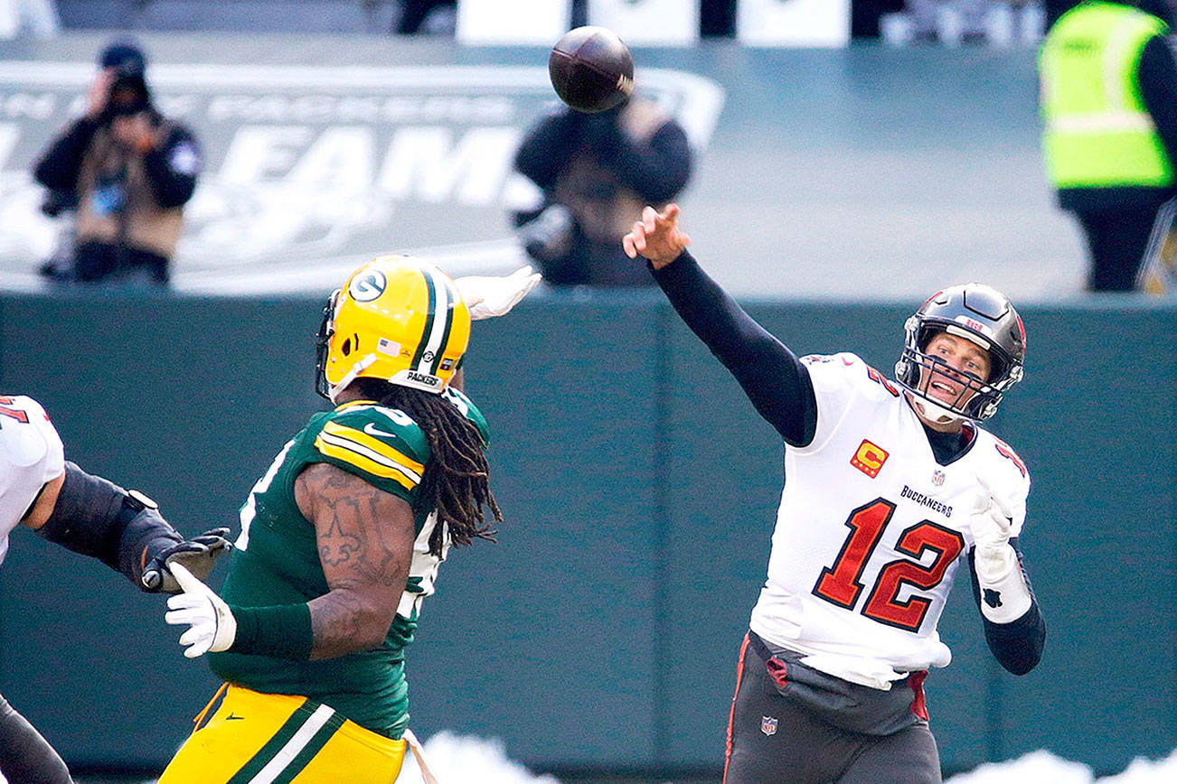 Tampa Bay Buccaneers quarterback Tom Brady (12) passes against the Green Bay Packers during the first half of the NFC championship NFL football game in Green Bay, Wis., Sunday, Jan. 24, 2021. (AP Photo/Mike Roemer)