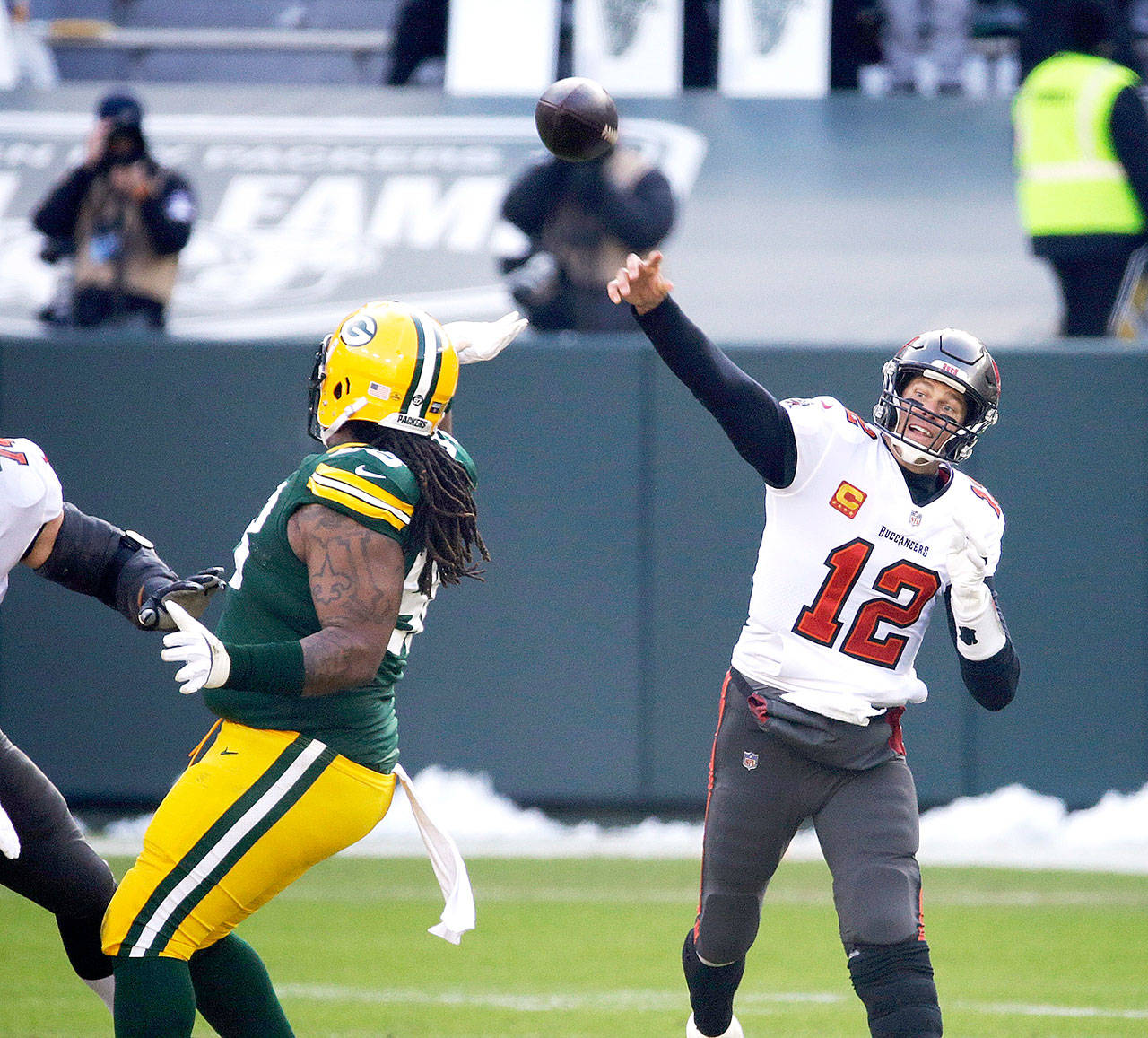 Tampa Bay Buccaneers quarterback Tom Brady (12) passes against the Green Bay Packers during the first half of the NFC championship NFL football game in Green Bay, Wis., Sunday, Jan. 24, 2021. (AP Photo/Mike Roemer)