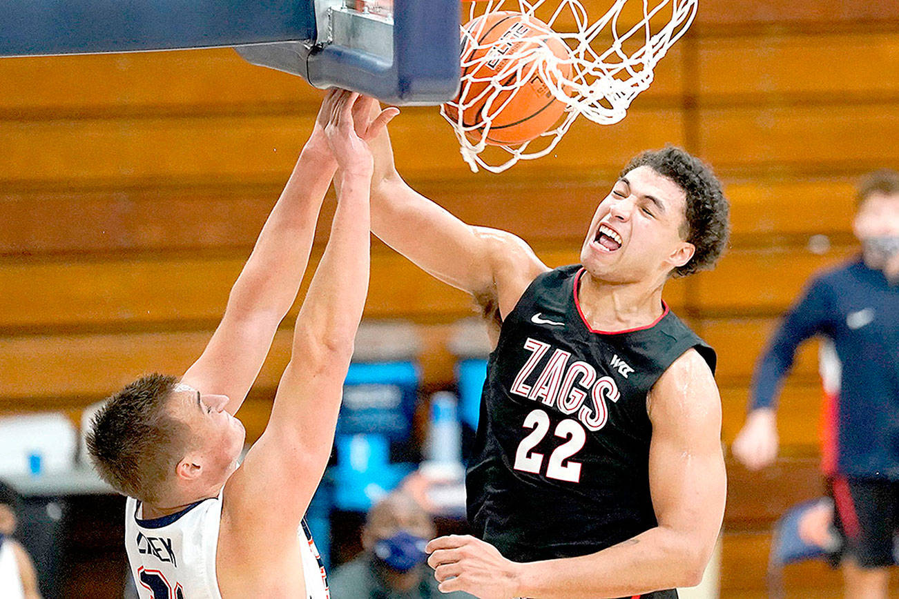 Gonzaga forward Anton Watson (22) dunks against Pepperdine forward Jan Zidek, left, during the second half of an NCAA college basketball game Saturday, Jan 30, 2021, in Malibu, Calif. (AP Photo/Ashley Landis)