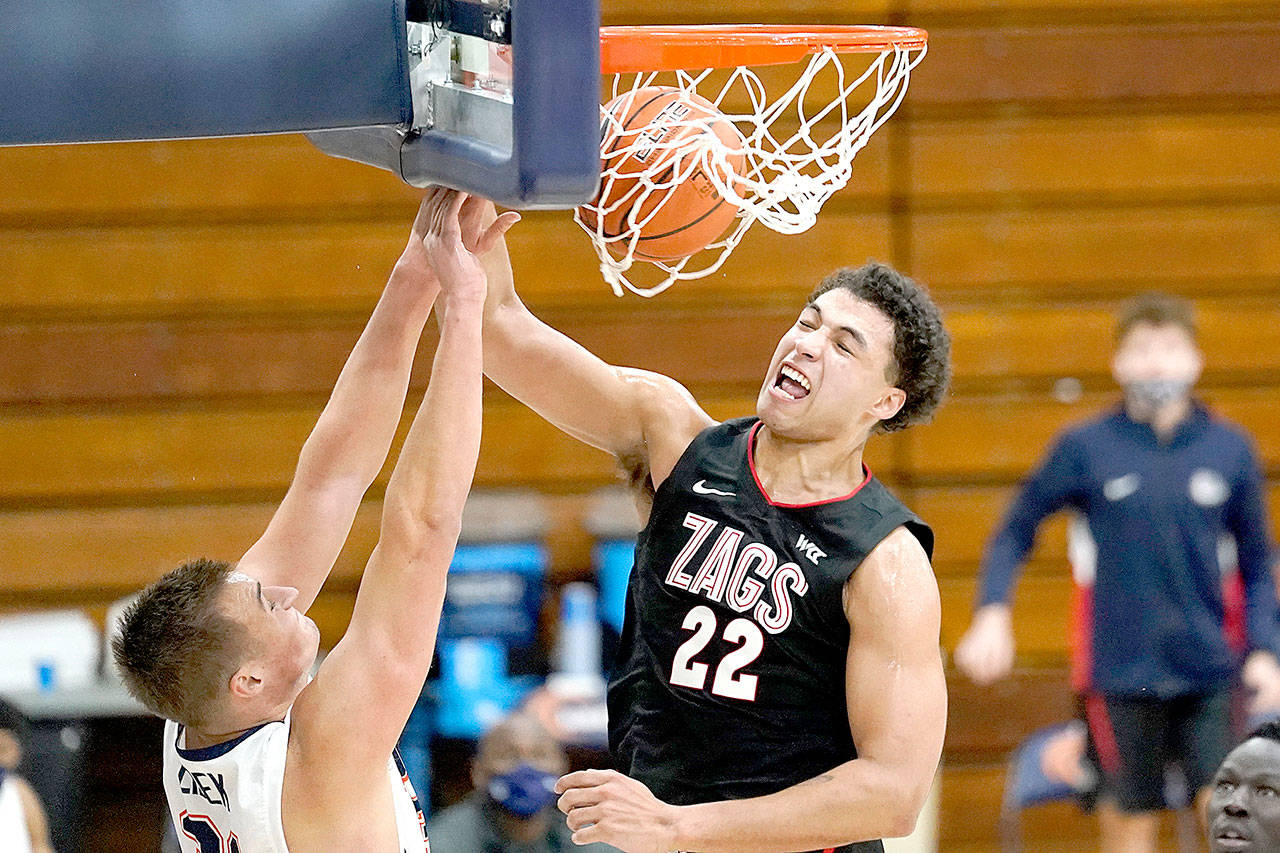 Gonzaga forward Anton Watson (22) dunks against Pepperdine forward Jan Zidek, left, during the second half of an NCAA college basketball game Saturday, Jan 30, 2021, in Malibu, Calif. (AP Photo/Ashley Landis)