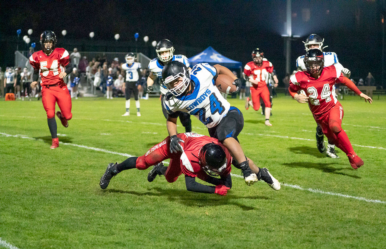 Port Townsend’s Tanner Woodley upends Chimacum’s Anson Jones during the 12th annual Andy Palmer Classic played in Memorial Field in November 2019. If contests can be played, the two rivals will combine for traditional fall sports for the WIAA’s Season 1 schedule.
(Steve Mullensky/for Peninsula Daily News)