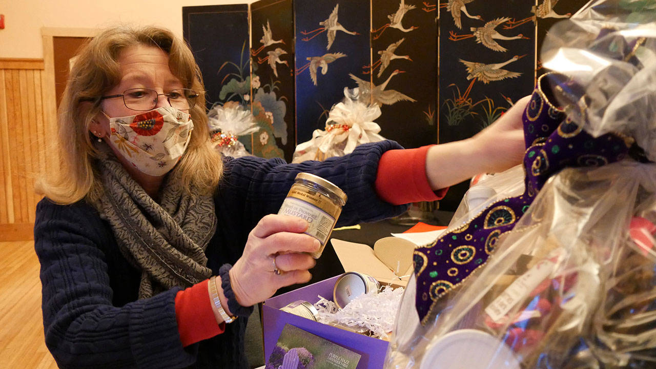 Cathy Wagner prepares some culinary delights baskets in the Olympic Theatre Arts Center’s Gathering Hall. (Photo courtesy of Olympic Theatre Arts Center)
