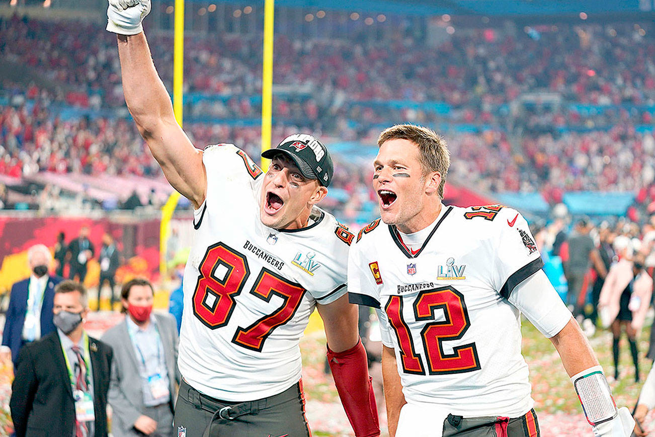 Tampa Bay Buccaneers tight end Rob Gronkowski (87), left, and Tampa Bay Buccaneers quarterback Tom Brady (12) celebrate together after the NFL Super Bowl 55 football game against the Kansas City Chiefs, Sunday, Feb. 7, 2021, in Tampa, Fla. The Tampa Bay Buccaneers defeated the Kansas City Chiefs 31-9. (AP Photo/Steve Luciano)