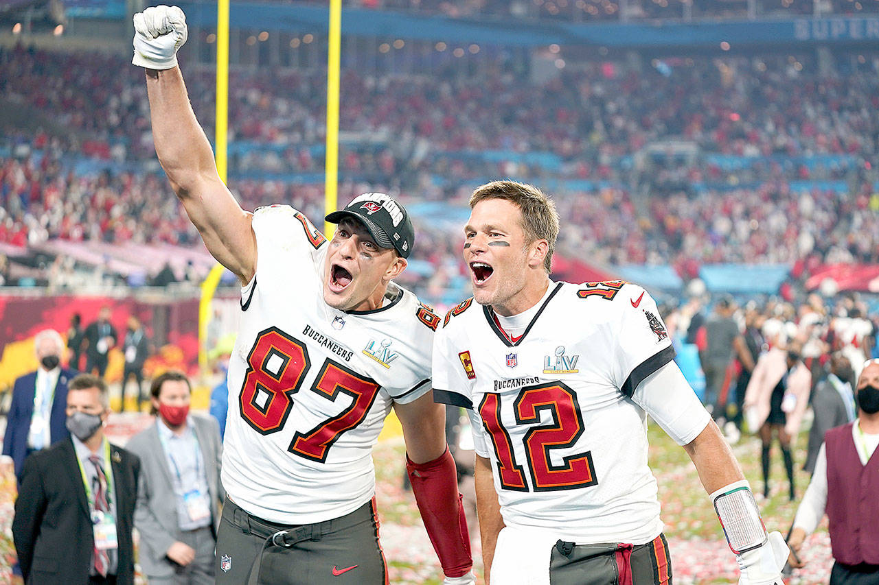 Tampa Bay Buccaneers tight end Rob Gronkowski (87), left, and Tampa Bay Buccaneers quarterback Tom Brady (12) celebrate together after the NFL Super Bowl 55 football game against the Kansas City Chiefs, Sunday, Feb. 7, 2021, in Tampa, Fla. The Tampa Bay Buccaneers defeated the Kansas City Chiefs 31-9. (AP Photo/Steve Luciano)